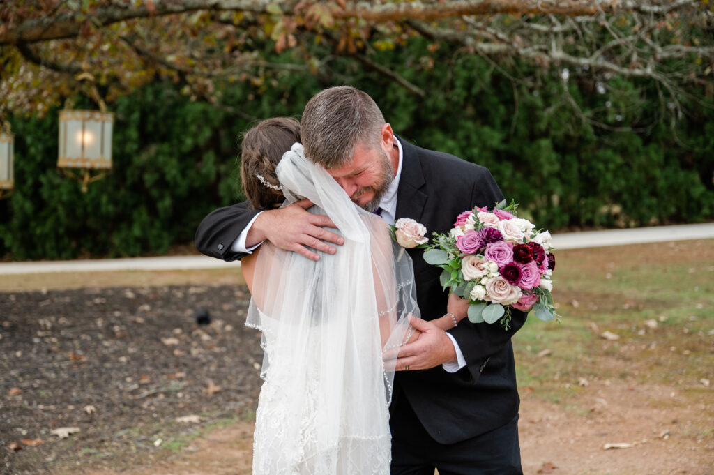 dad hugging his daughter on her wedding day and getting emotional